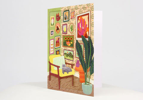 3 Dimensional card showing interior with gallery walls, chair and a cat. Large card with envelope by UWP Luxe.