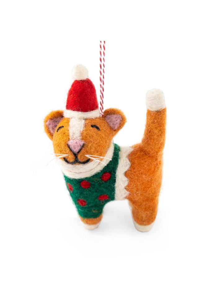 Felted cat ornament wearing a Santa hat and green sweater with red polka dots on a white background