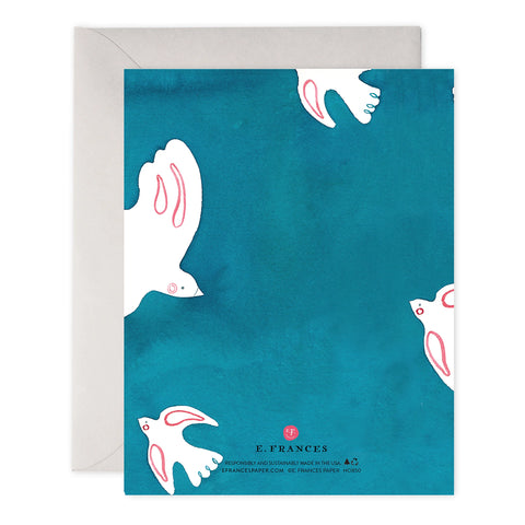 Greeting card with white doves on a blue background, featuring the brand 'E. Frances'.