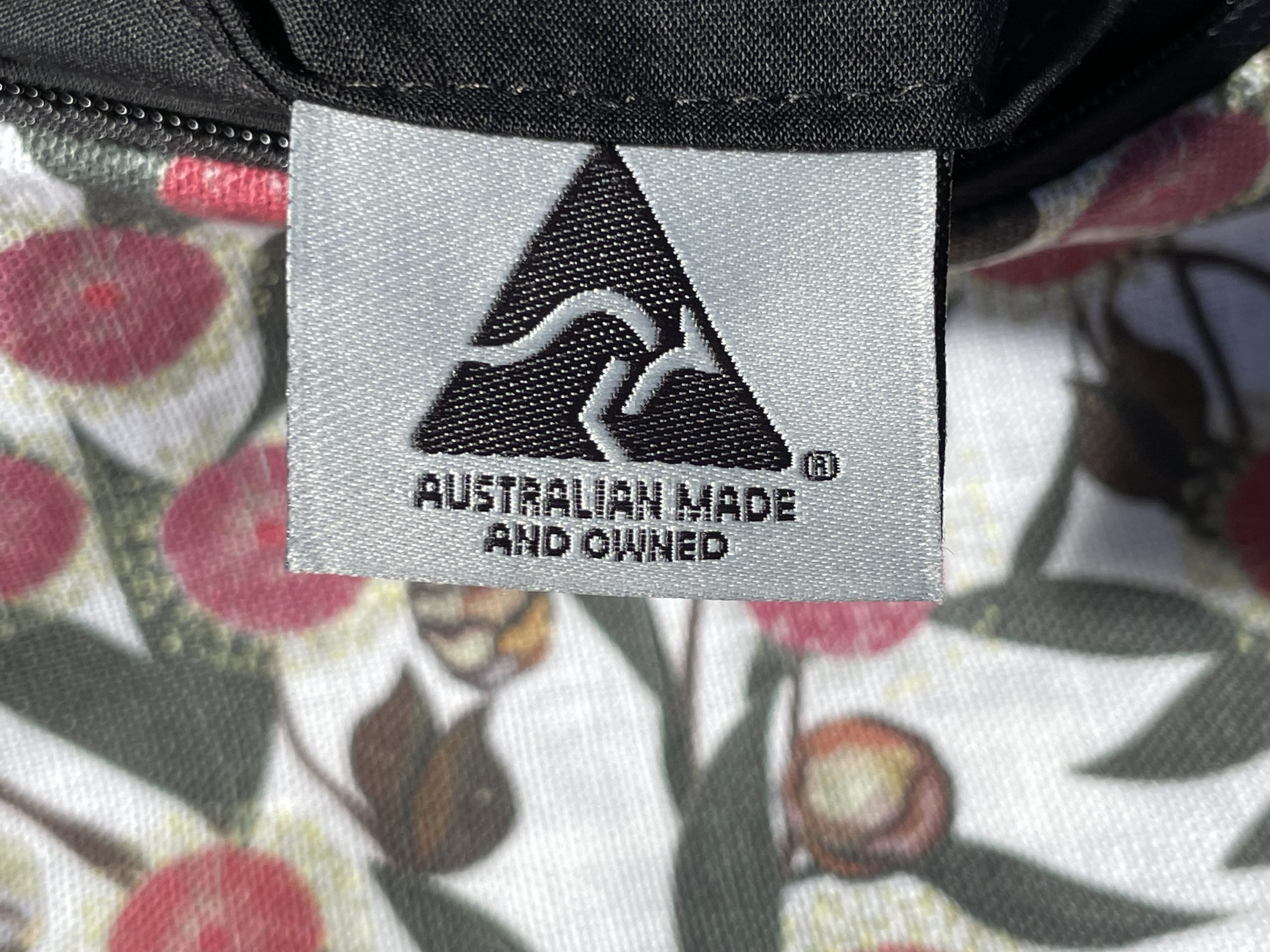 Label indicating 'Australian Made and Owned' on a product with a floral pattern.