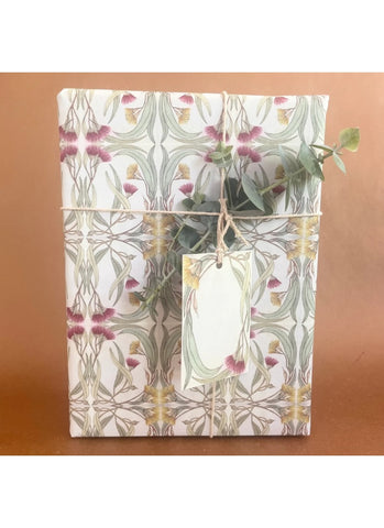 Gift box with floral pattern and plant on a brown background
