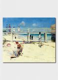 A beach scene with a bridge in the background and people on chairs