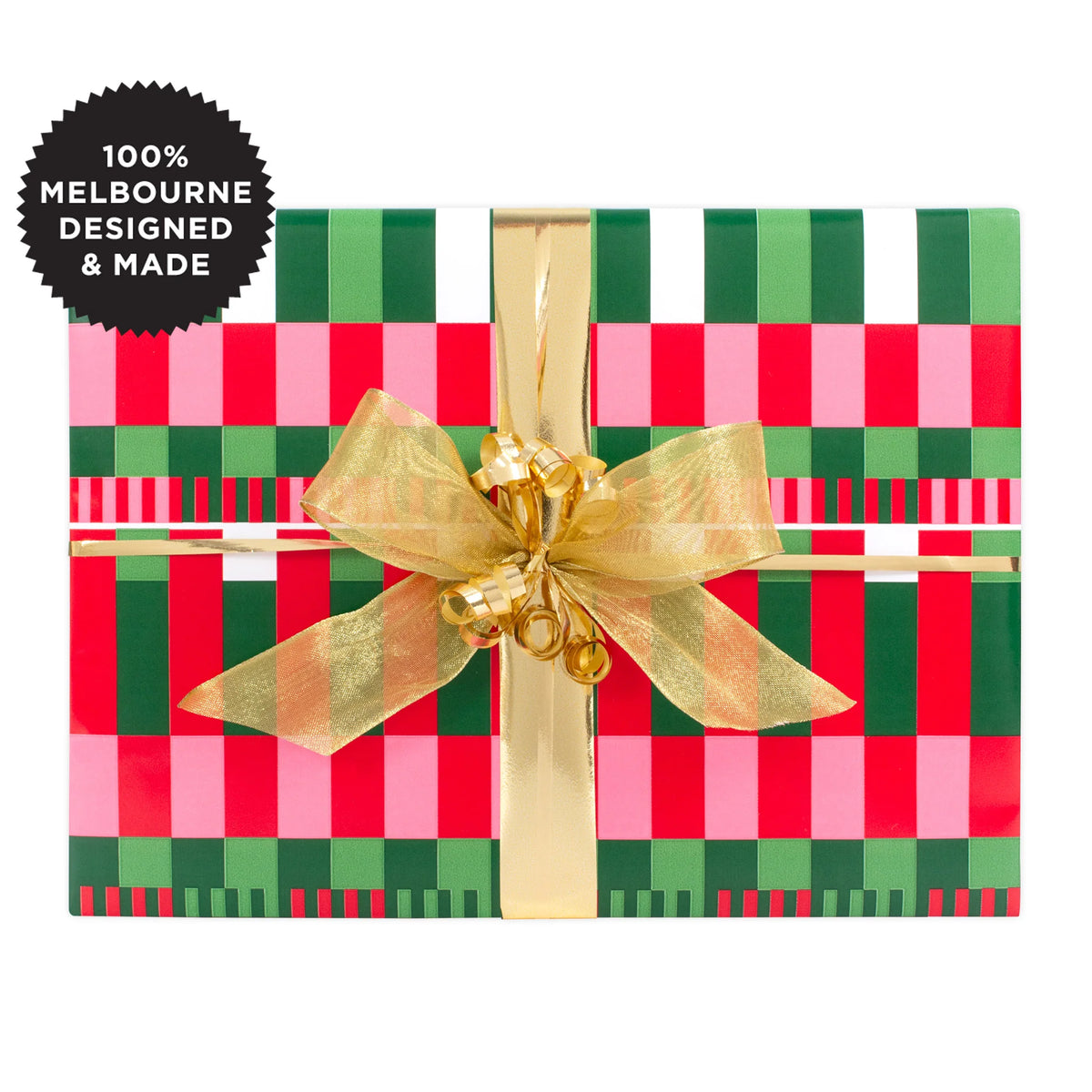A gift wrapped with a geometric pattern of pink, green and white.