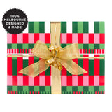 A gift wrapped with a geometric pattern of pink, green and white.
