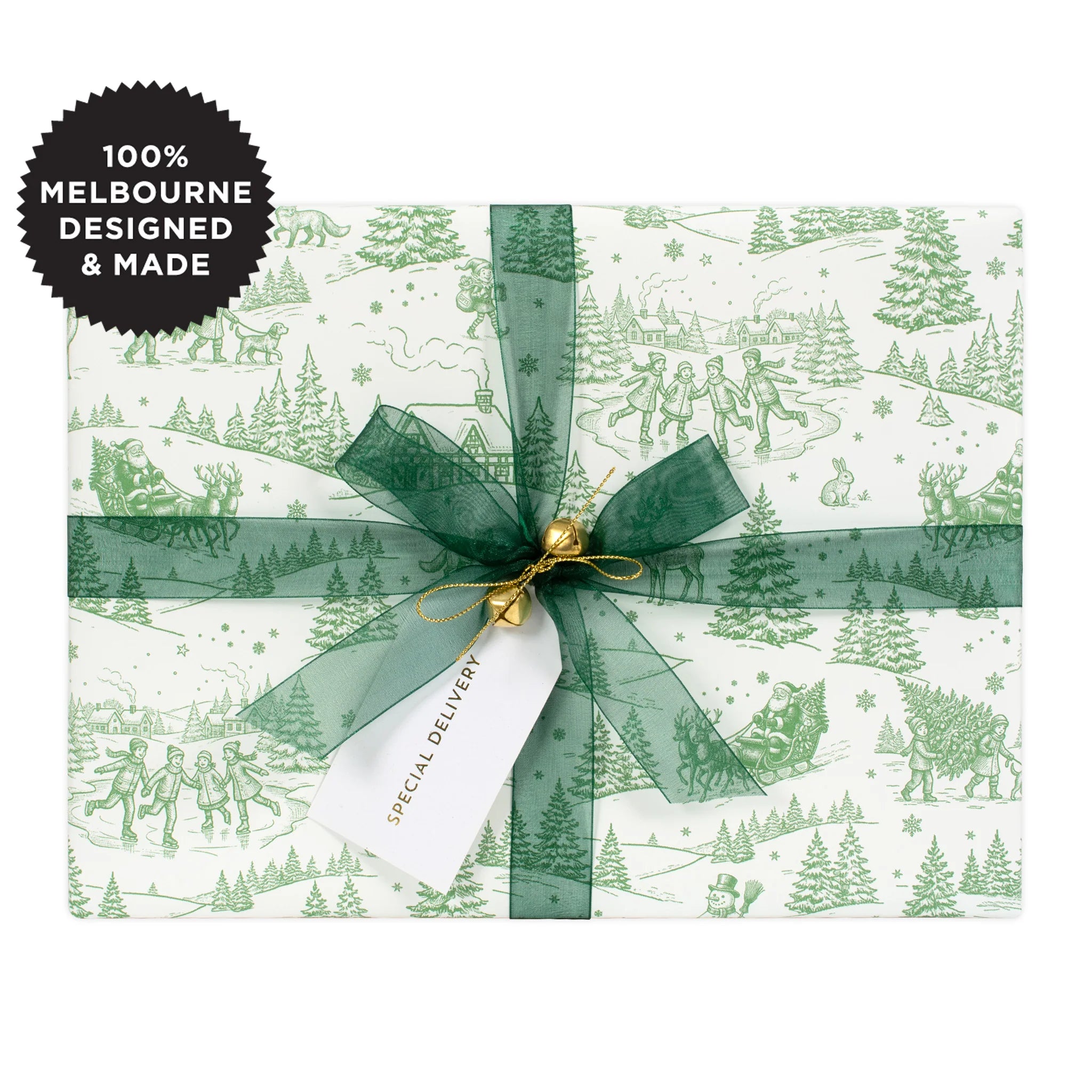 A gift wrapped in a green Christmas scene on white with a green ribbon.