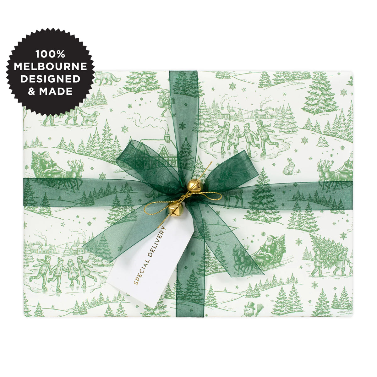 A gift wrapped in a green Christmas scene on white with a green ribbon.