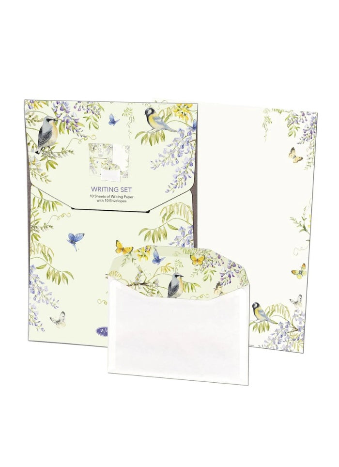 Writing set with stationery items featuring bird and floral designs on a white background