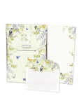 Writing set with stationery items featuring bird and floral designs on a white background