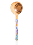 Wooden spoon with a colorful handle on a white background