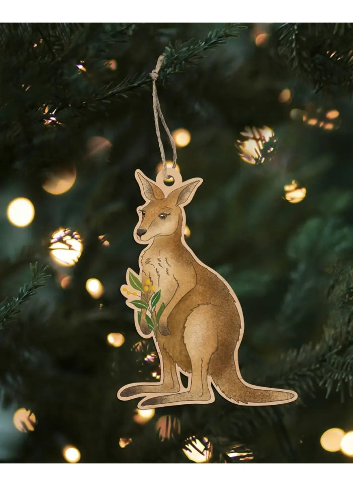 Kangaroo ornament hanging on a Christmas tree with lights in the background