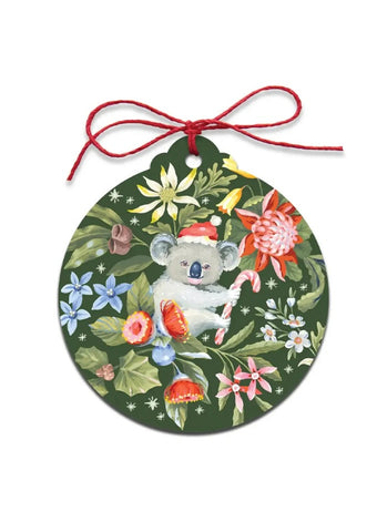 Decorative ornament with a koala bear holding a candy cane, surrounded by flowers on a green background.