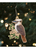 Decorative kookaburra ornament hanging on a Christmas tree with lights in the background.