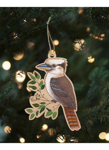 Decorative kookaburra ornament hanging on a Christmas tree with lights in the background.