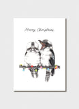 A white card with 2 kookaburras sitting on a branch with fairy lights.
