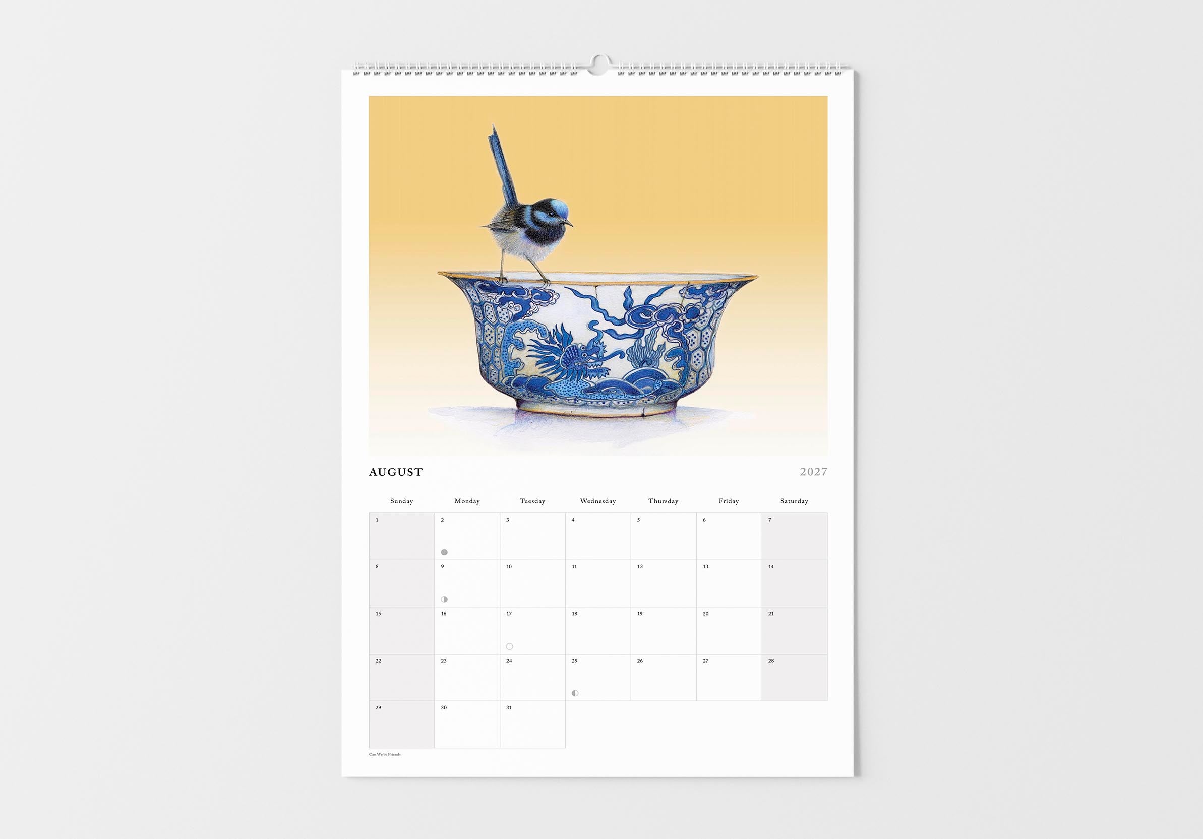 Calendar with a blue and white ceramic bowl design on a beige background