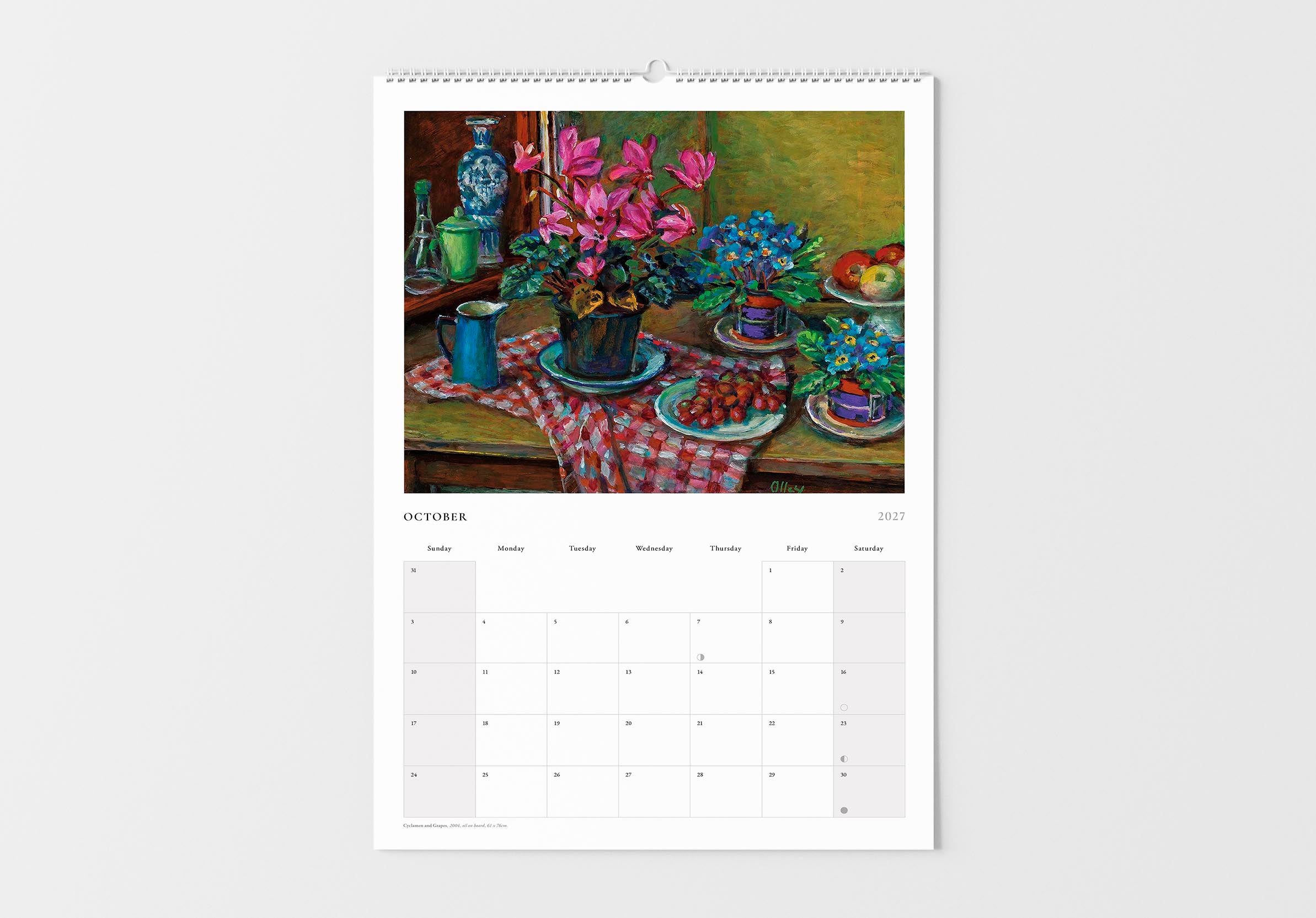 Calendar with a still life painting of flowers and fruit on a table, displayed on a white wall.