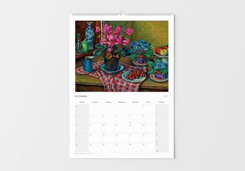 Calendar with a still life painting of flowers and fruit on a table, displayed on a white wall.