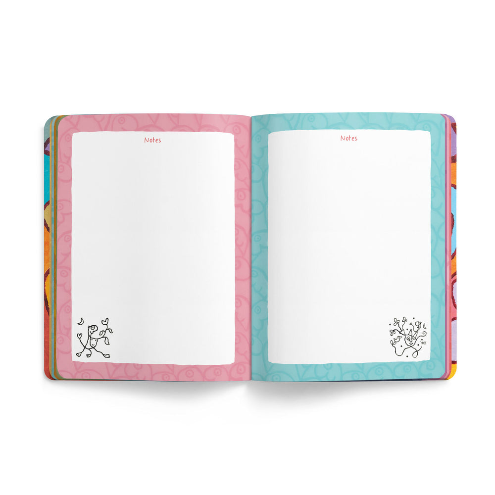 An open notebook or planner showing two blank writing pages. The left page border is pink with a subtle floral pattern, and the right page border is turquoise with a subtle wavy pattern.