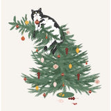 A Christmas tree leaning to the left and a cat on the top with a bauble in its mouth