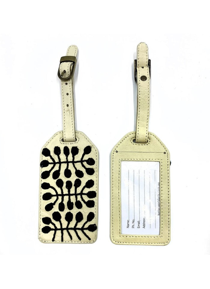 A cream with black embroidery leather luggage tag - back and front views.