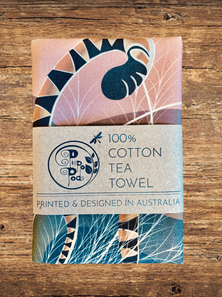 Tea towel with a decorative design on a wooden surface