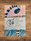Tea towel with a decorative design on a wooden surface