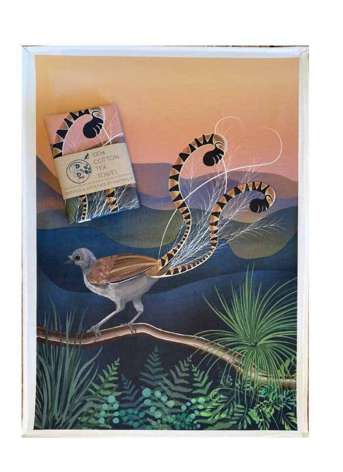 Teatowel with a lyrebird on a branch with mountains in the background.