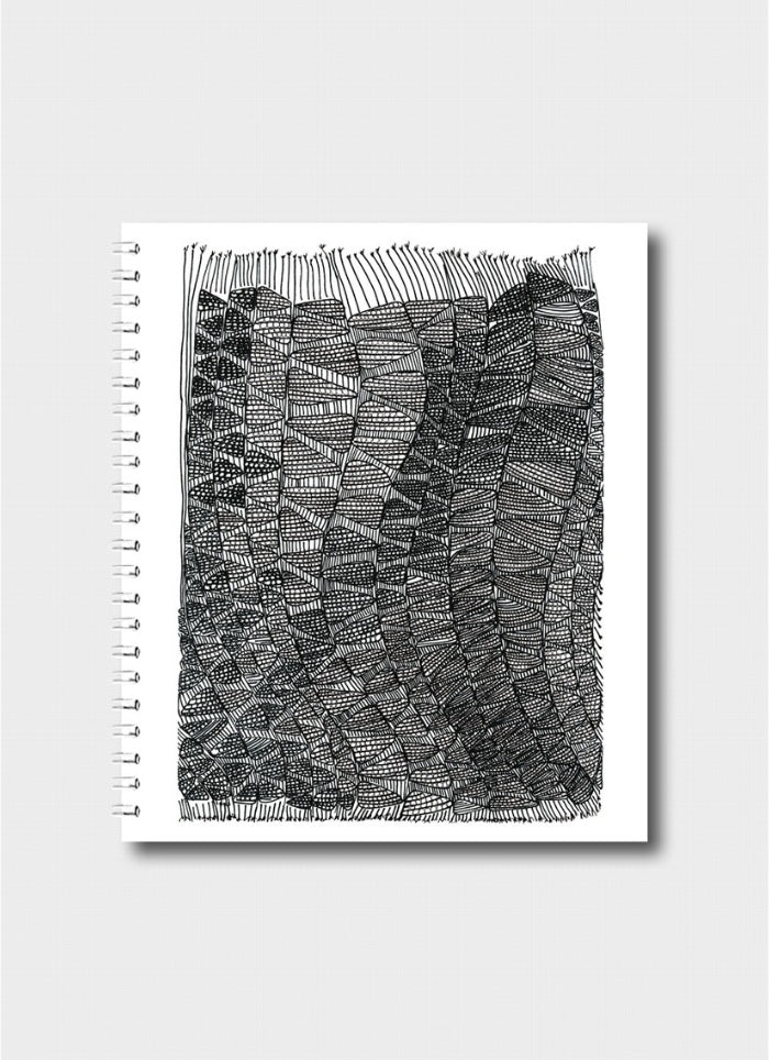 Notebook with a black and white geometric pattern on a white background