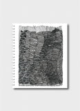 Notebook with a black and white geometric pattern on a white background