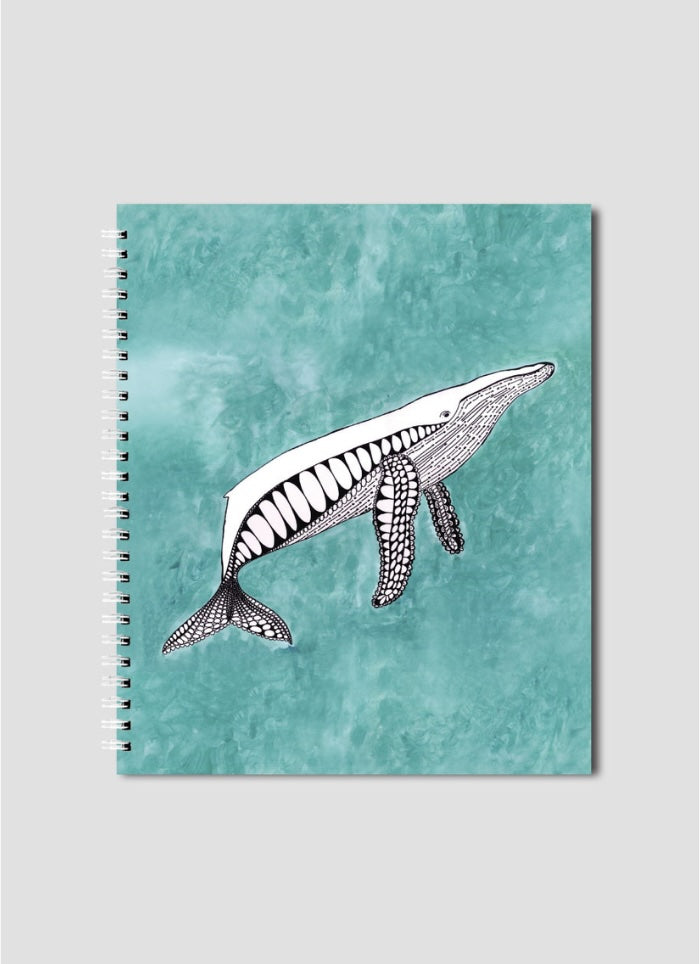 Notebook with whale illustration on a teal background