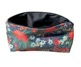 Floral-patterned pouch with a black interior on a white background