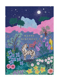 Birthday card with a zebra in a colorful landscape at night.