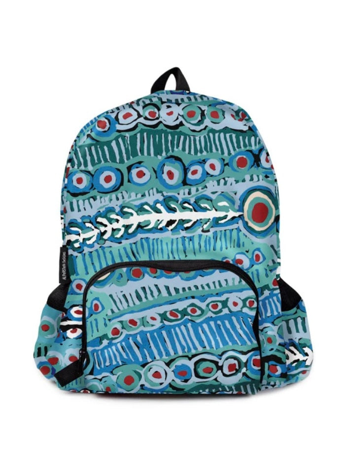 A backpack featuring a vibrant, hand-drawn style pattern in shades of blue, teal, green, and red, with white fish skeleton details across the front. The backpack has a black top handle, black side straps, and a black front zipper pocket.