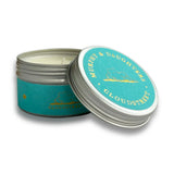 An open round metal tin candle with a turquoise label and silver lid, shown on a white background. The label reads 'MURPHY & DAUGHTERS CLOUDSTREET' with a small gold mountain illustration.