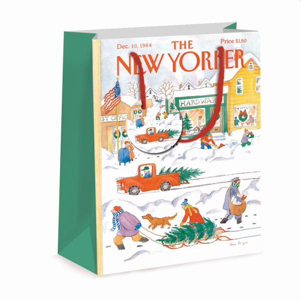 Gift bag with he New Yorker and an illustration of a town under snow at Christmas