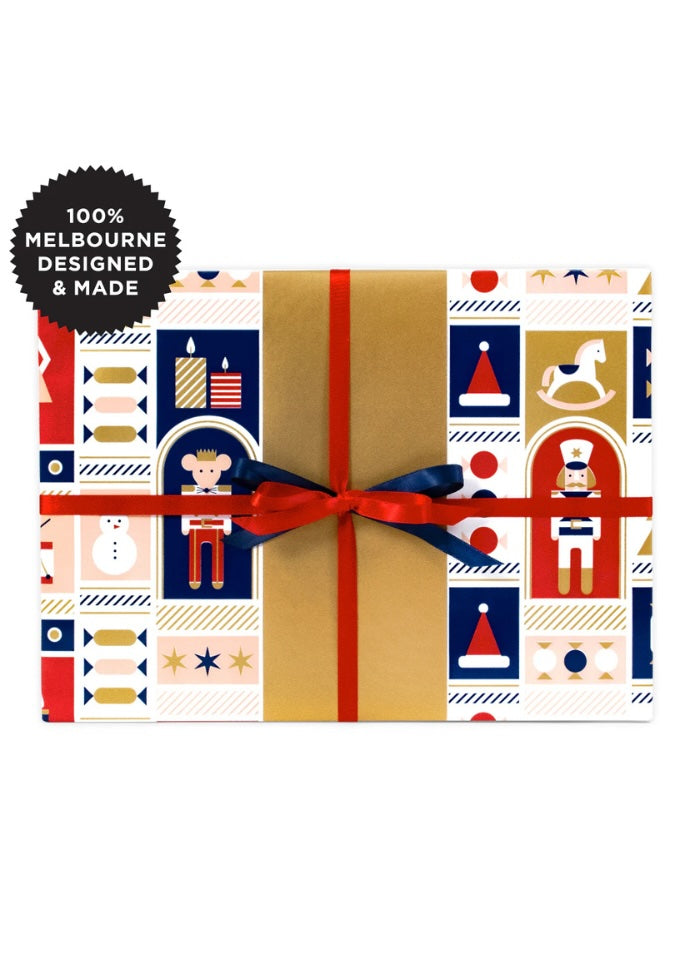 Gift box with festive pattern and red ribbon, labeled '100% Melbourne Designed & Made'.