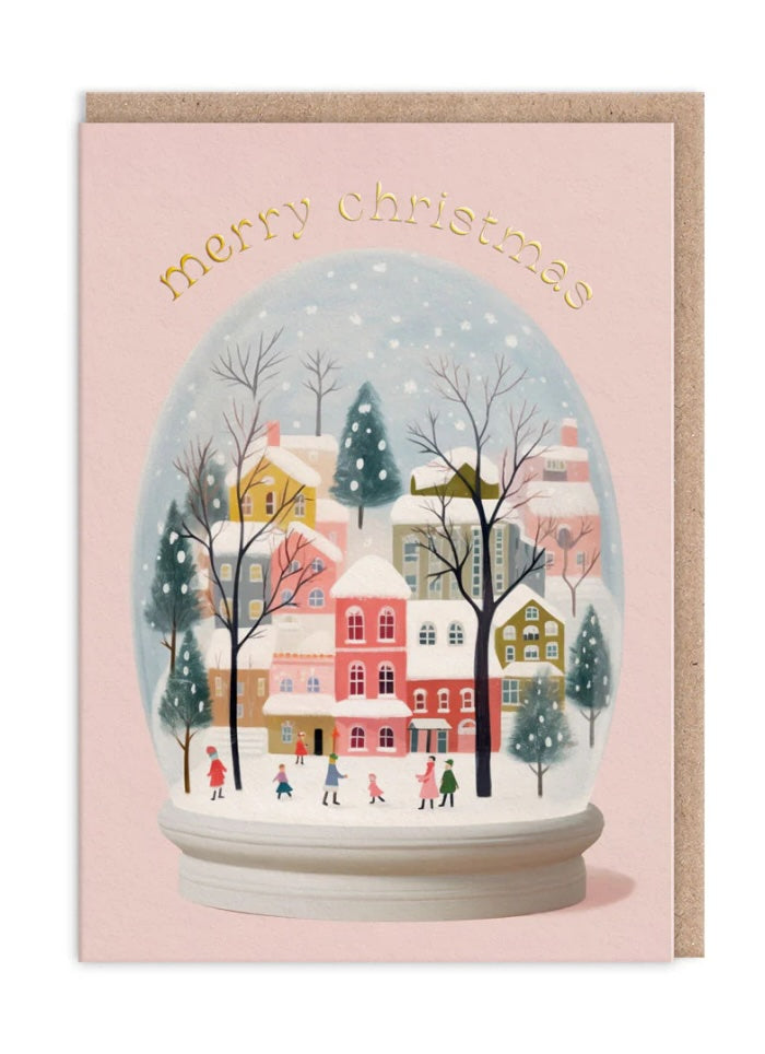 Pink card with a snow globe containing a snowy scene