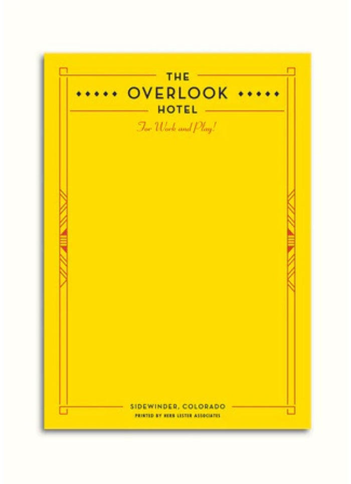 Yellow notepad with 'The Overlook Hotel' text on a white background