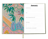 Journal with a colorful design on the left page and a blank page on the right for writing goals.