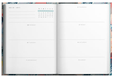 Open planner with calendar and weekly layout on a floral background