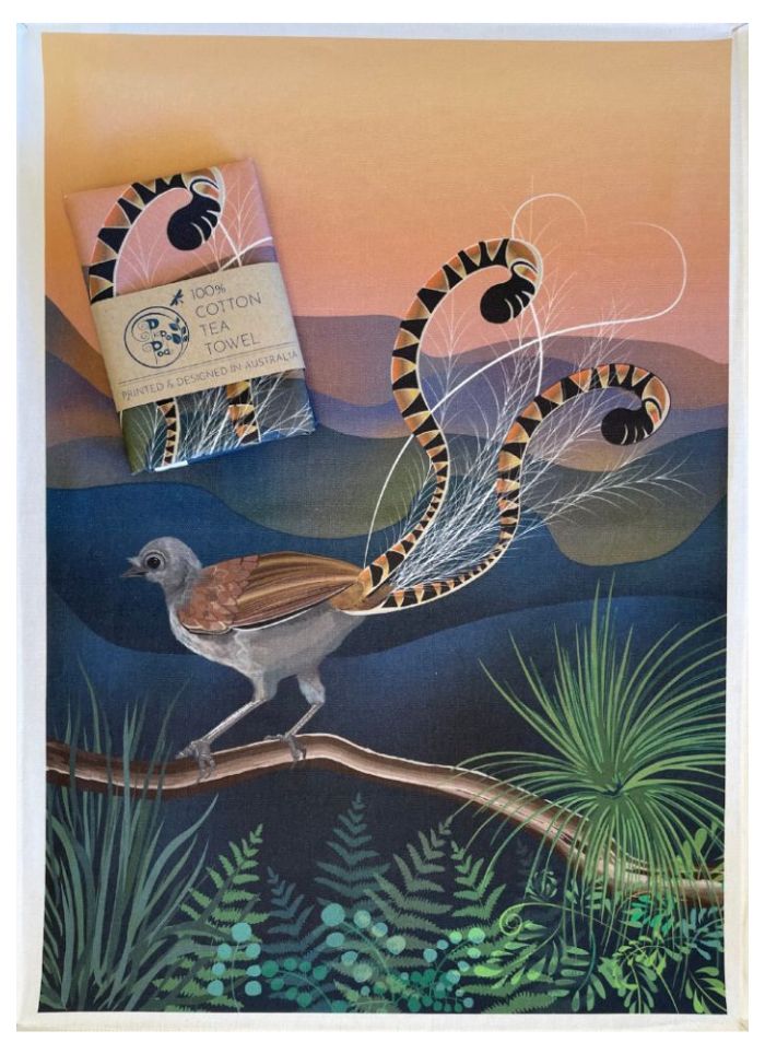 Artistic depiction of a bird with long feathers and a box labeled 'Cotton Tea Towel' on a scenic background.