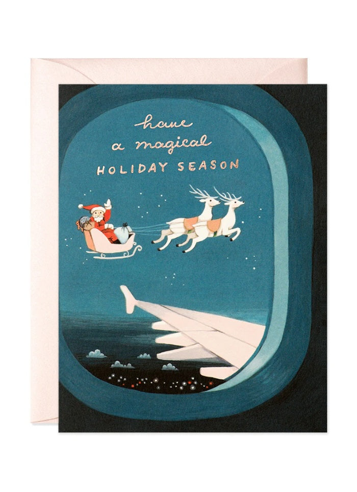 Blue card with a picture of sata and his reindeer.