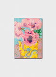 Pink poppy flowers in a yellow jug with a green dragon.