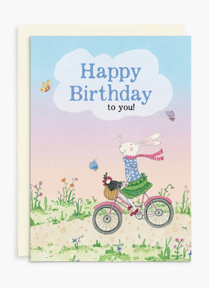 Card with a rabbit riding a bike and says Happy Birthday to you