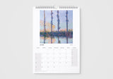 Calendar with a painting of trees and water on a white background