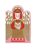 A stylized paper-cut style illustration of an angel with red hair and wings, holding a book with the word 'NOEL' visible, on a white background.