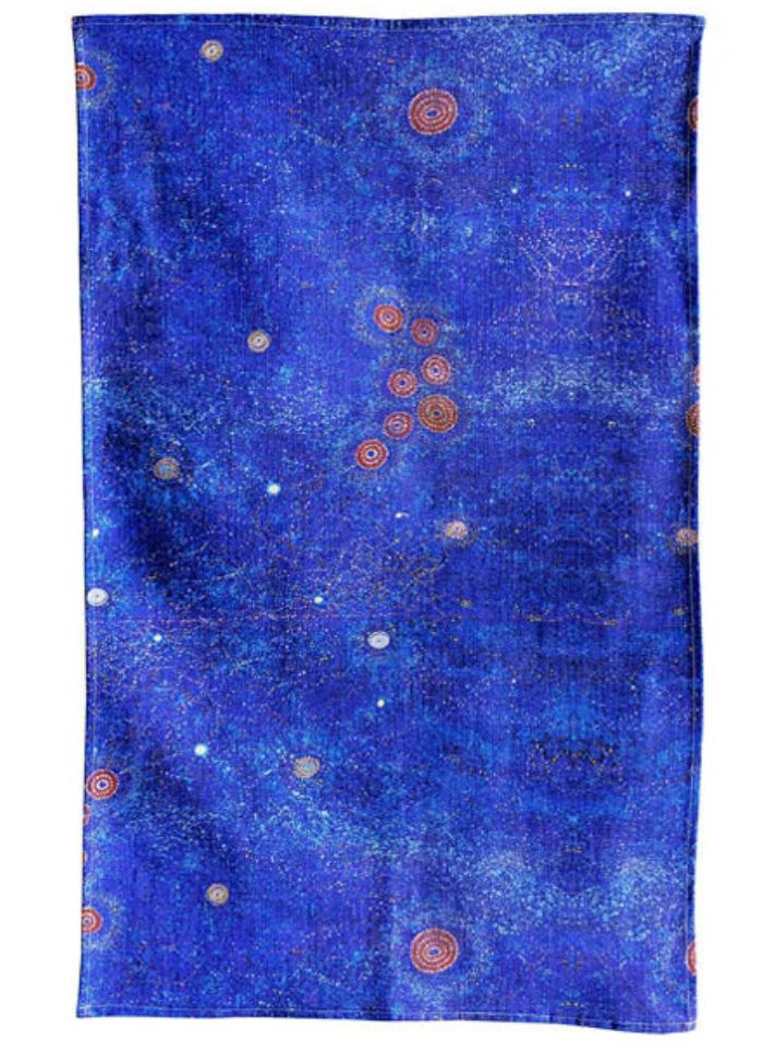 Blue patterned fabric with circular designs on a white background
