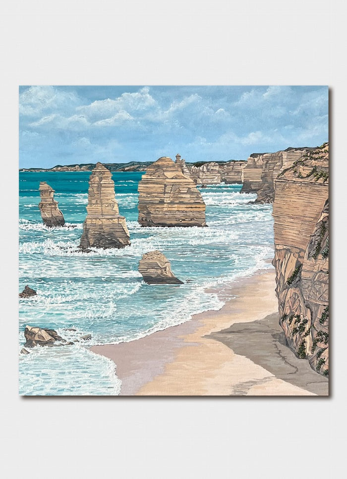 Scenic view of a beach with rock formations and ocean waves.