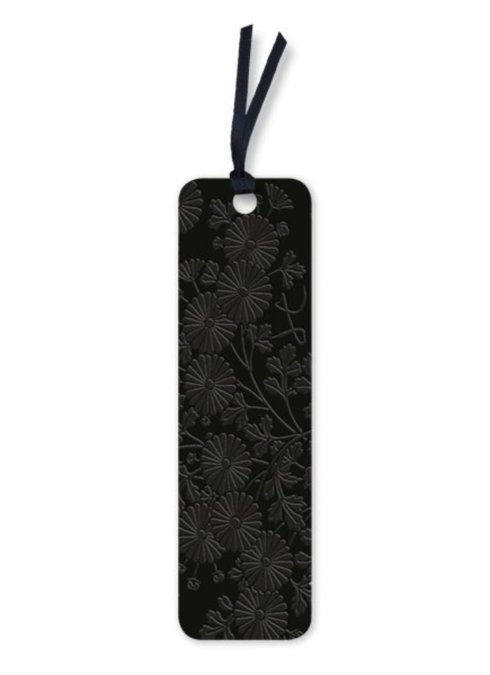 Black floral embossed bookmark with a string on a white background