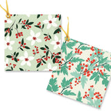 2 gift tags with green, red and white foliage and gold string.